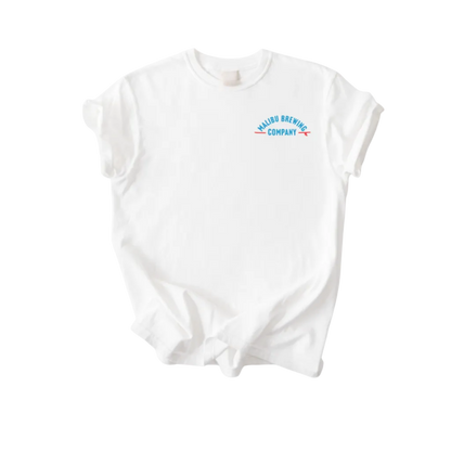 The Red, White & 'Bu Tee is a unisex white shirt with rolled sleeves and a small blue and orange Malibu Brewing Company logo on the upper left chest. This classic summer tee is shown laid flat against a white background.